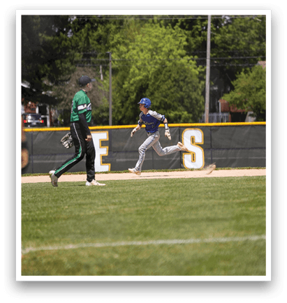 A baseball player running to a base. Description generated by AI