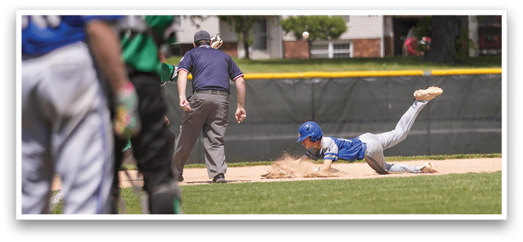 A baseball player slides into home plate. Description generated by AI