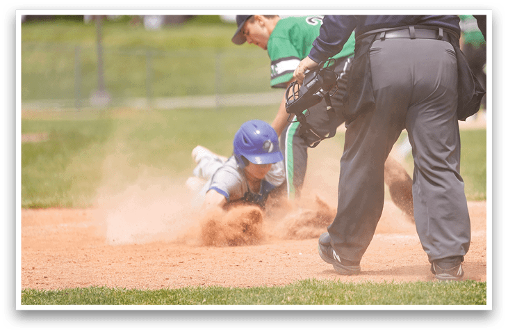 A baseball player slides into a base. Description generated by AI