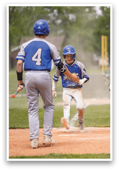 A baseball player is running to the base. Description generated by AI