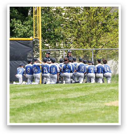 Baseball players in blue uniforms. Description generated by AI