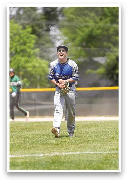 A baseball player in a blue and white uniform is running towards the base. Description generated by AI