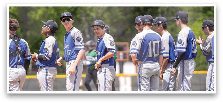 A group of baseball players standing on a field. Description generated by AI