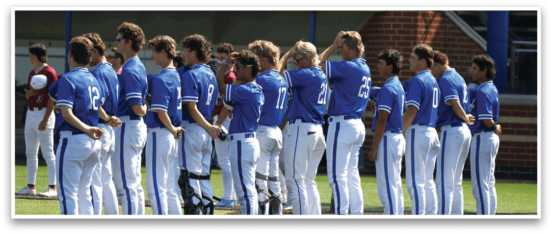 A group of baseball players standing on a field. Description generated by AI