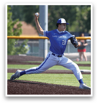 A baseball player in a blue uniform is pitching a ball. Description generated by AI