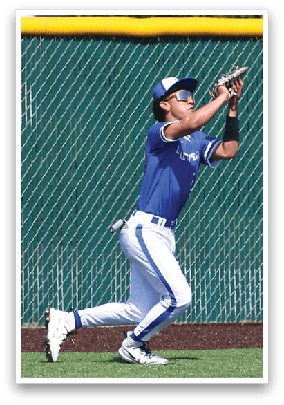 A baseball player wearing a blue shirt and white pants catching a ball. Description generated by AI