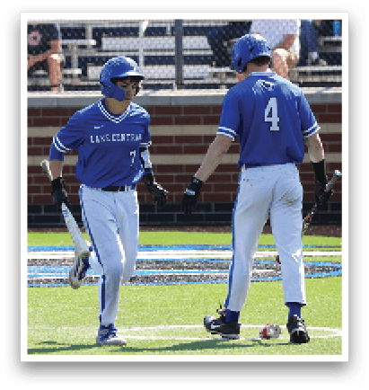 Two baseball players wearing blue and white uniforms. Description generated by AI