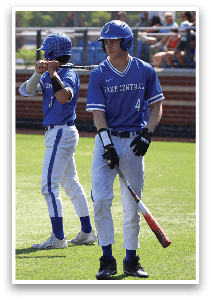 Two baseball players standing on a field. Description generated by AI