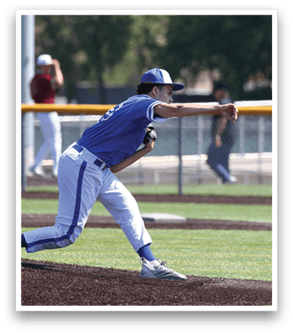 A baseball player in a blue uniform is throwing a ball. Description generated by AI