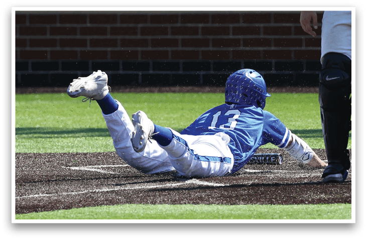 A baseball player sliding into a base. Description generated by AI