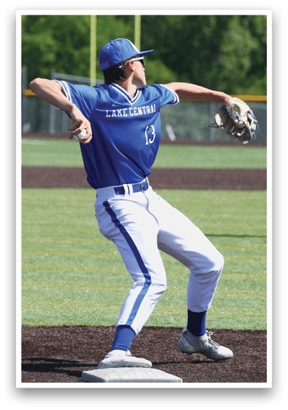 A baseball player in a blue and white uniform is throwing a ball. Description generated by AI