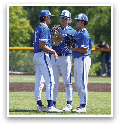 Three baseball players wearing blue and white uniforms. Description generated by AI