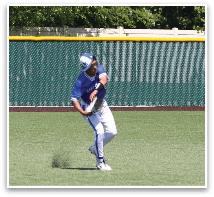 A baseball player in a blue uniform is holding a bat and getting ready to hit a ball. Description generated by AI