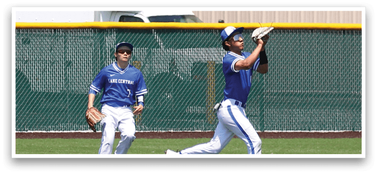 A baseball player in a blue uniform catching a ball. Description generated by AI