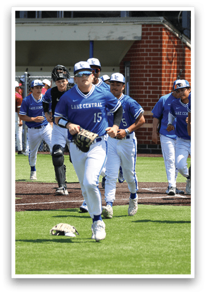 A baseball player wearing a blue shirt and white pants is running on the field. Description generated by AI