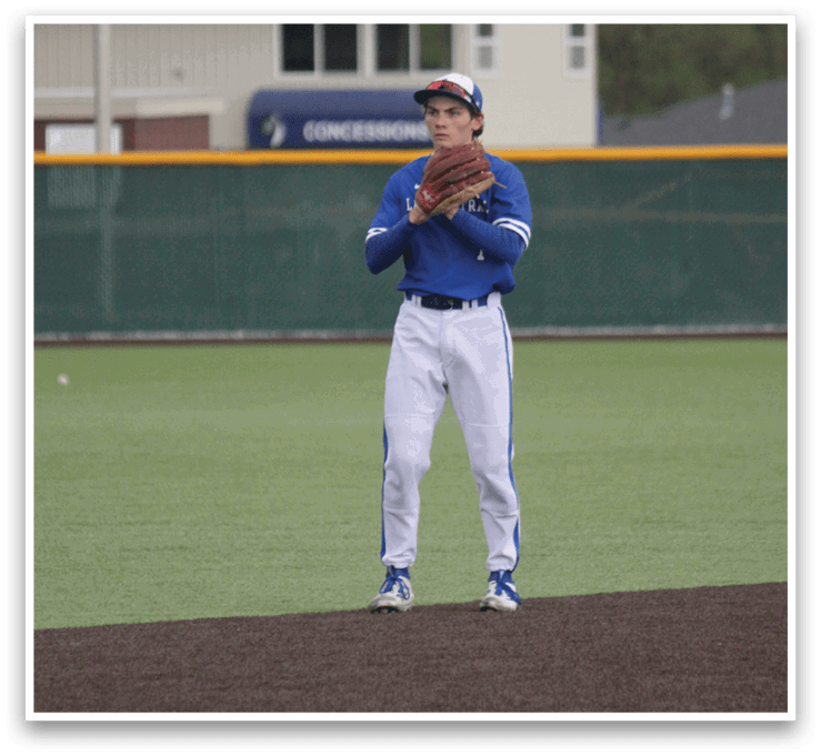 A baseball player in a blue and white uniform holding a baseball. Description generated by AI