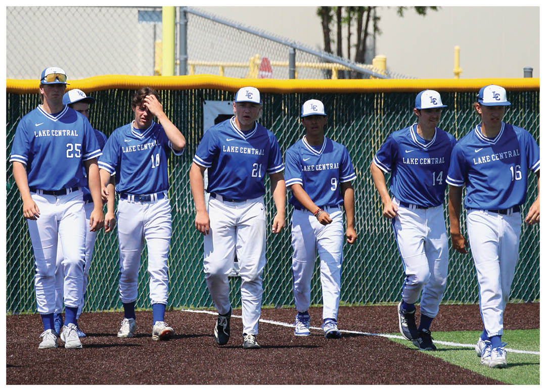 A group of baseball players wearing blue uniforms. Description generated by AI