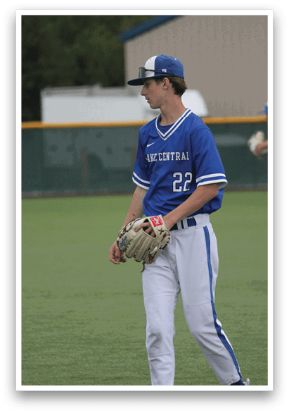 A baseball player wearing a blue and white uniform. Description generated by AI