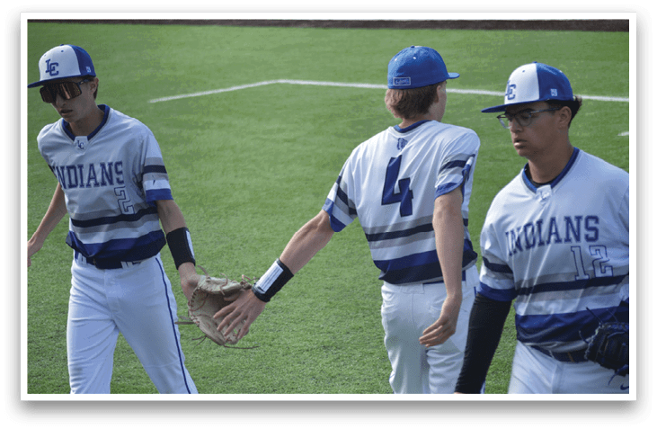A group of men wearing blue and white uniforms. Description generated by AI