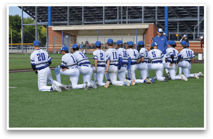 Baseball players wearing blue and white uniforms. Description generated by AI