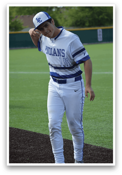 A baseball player wearing a white and blue uniform. Description generated by AI