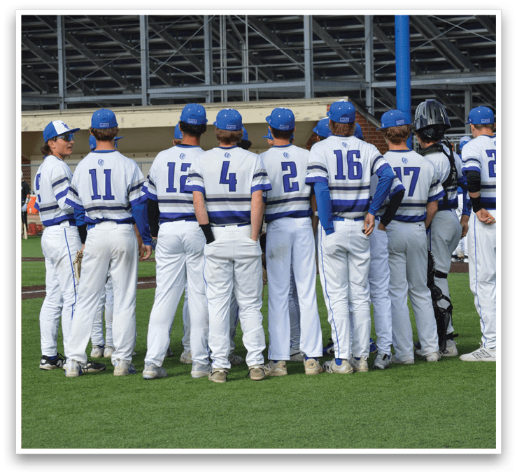 A group of baseball players wearing blue and white uniforms. Description generated by AI