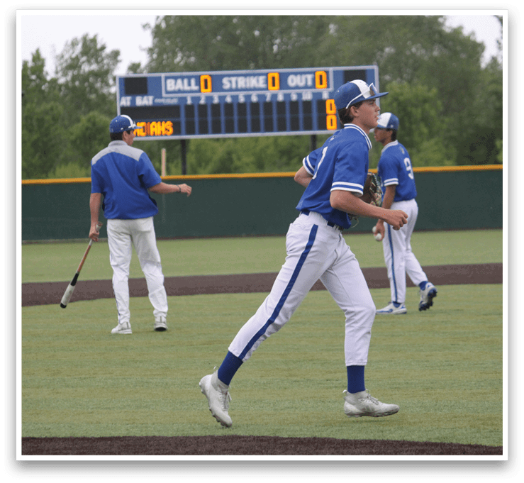 A baseball player wearing a blue and white uniform. Description generated by AI