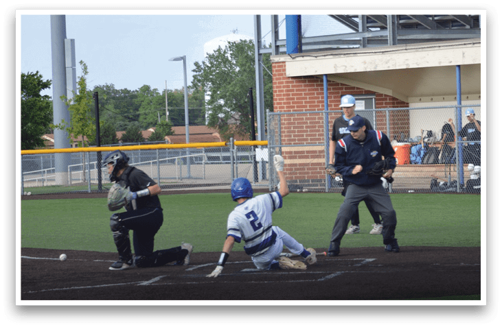 A baseball player sliding into home plate. Description generated by AI
