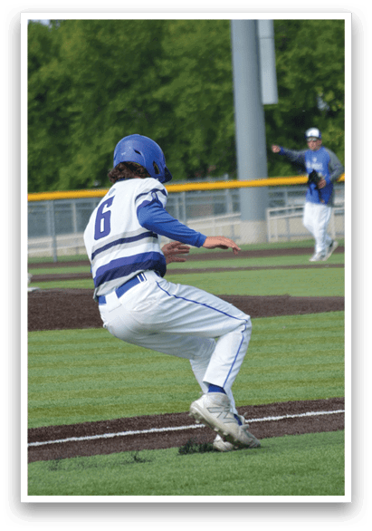A baseball player wearing a blue helmet and white pants is bending over on the field. Description generated by AI