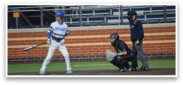 A baseball player is holding a bat and getting ready to hit the ball. Description generated by AI