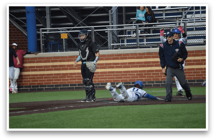 A baseball player slides into home plate. Description generated by AI