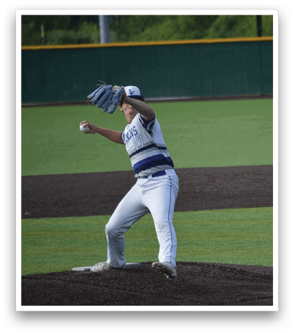 A baseball player in a blue and white uniform is pitching a ball. Description generated by AI