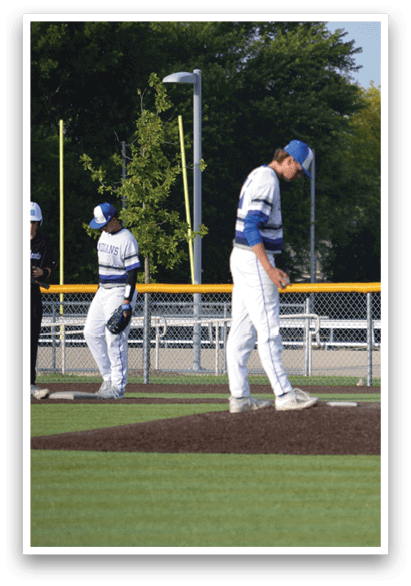 Two baseball players standing on a field. Description generated by AI