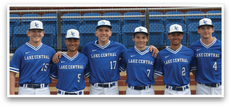 A group of baseball players wearing blue and white uniforms. Description generated by AI