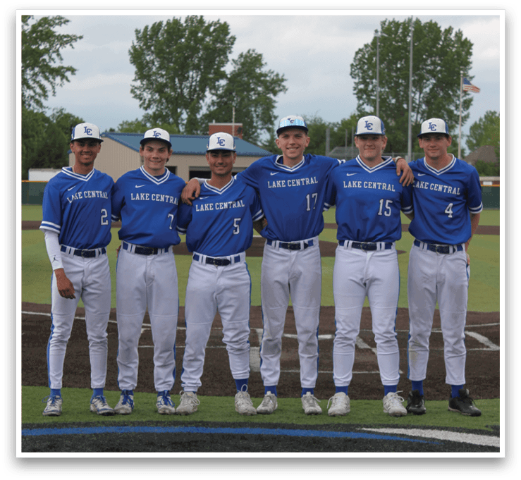 A group of baseball players wearing blue uniforms and white hats. Description generated by AI