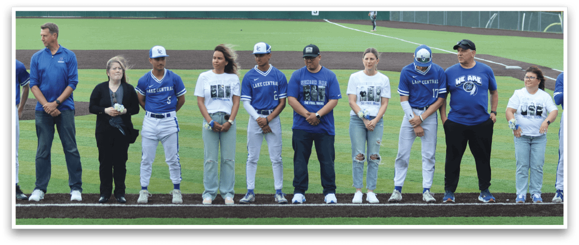Baseball players standing on a field. Description generated by AI