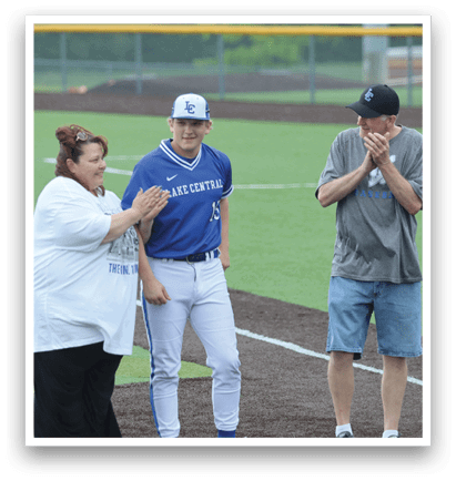 A man and woman are standing on a baseball field. Description generated by AI
