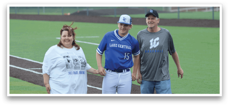 A man and woman standing on a baseball field. Description generated by AI