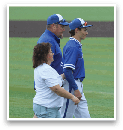 A man wearing a blue shirt and white hat. Description generated by AI