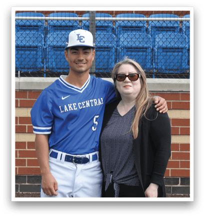 A man and woman standing on a baseball field. Description generated by AI