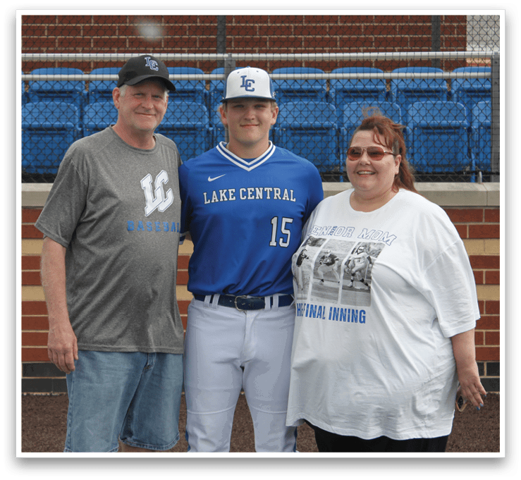 A man and woman are standing next to a baseball player. Description generated by AI