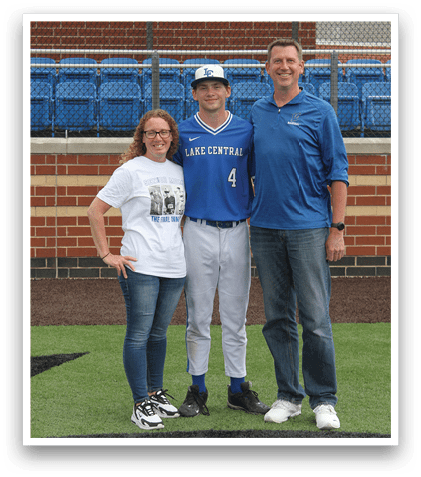 Three people standing on a baseball field. Description generated by AI