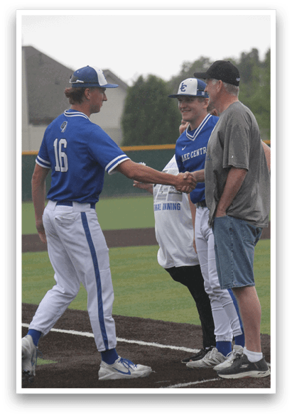 A baseball player shakes hands with a coach. Description generated by AI