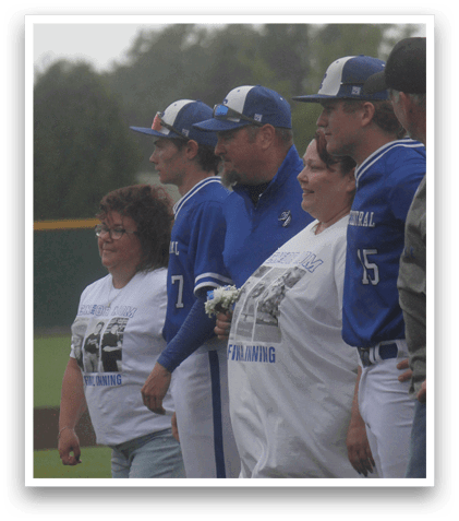 A group of people wearing blue and white shirts. Description generated by AI