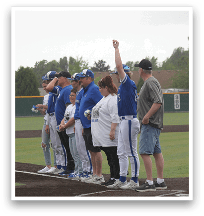 A group of people standing on a baseball field. Description generated by AI