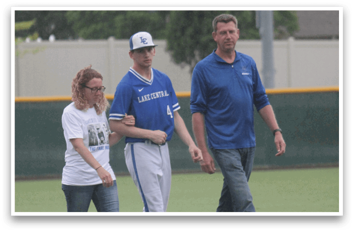 Three people walking on a baseball field. Description generated by AI