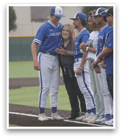 A group of people wearing blue and white uniforms. Description generated by AI
