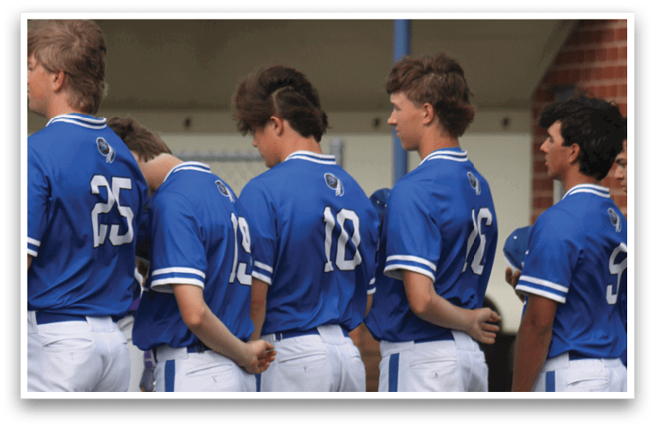 A group of baseball players wearing blue and white uniforms. Description generated by AI