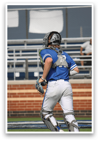 A baseball player in a blue and white uniform is holding a baseball glove. Description generated by AI