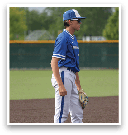 A baseball player wearing a blue and white uniform. Description generated by AI